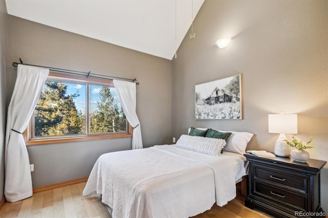 bedroom featuring light hardwood / wood-style flooring and vaulted ceiling