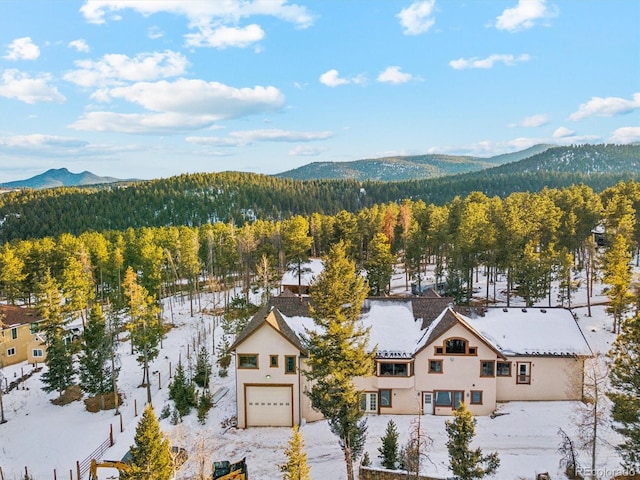 snowy aerial view with a mountain view