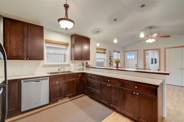 kitchen featuring a sink, stainless steel dishwasher, a peninsula, and light countertops