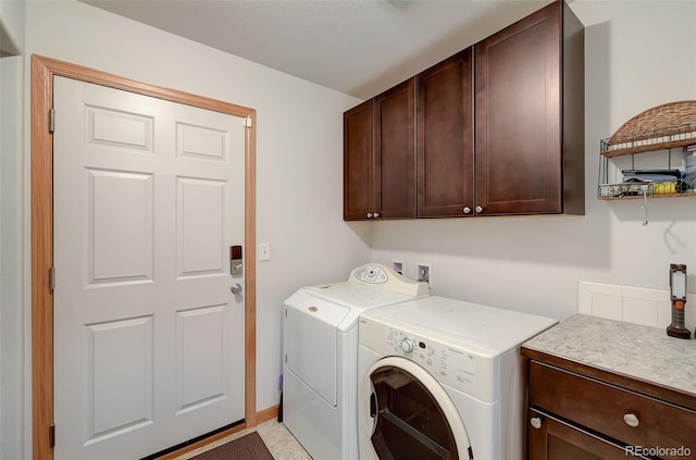 washroom with washer and clothes dryer and cabinet space