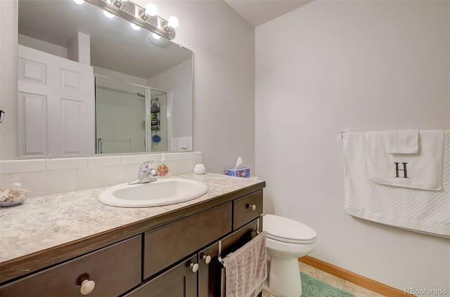 full bath with baseboards, toilet, a stall shower, and vanity