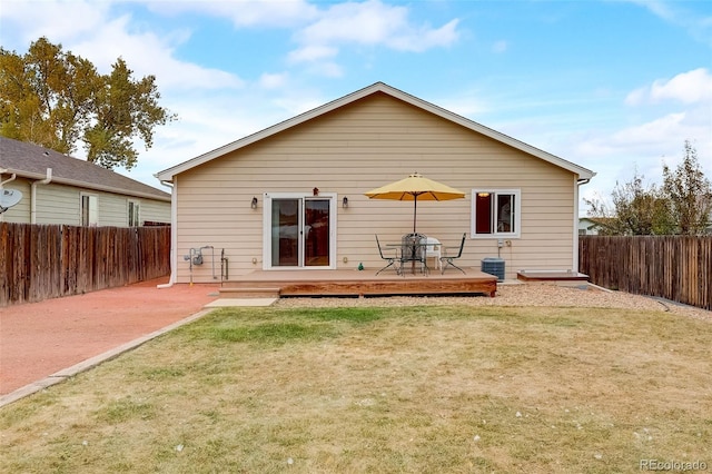 back of house with a yard, a deck, central AC, and a fenced backyard