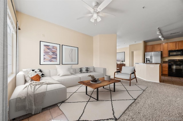 living room featuring visible vents, light colored carpet, a ceiling fan, and track lighting