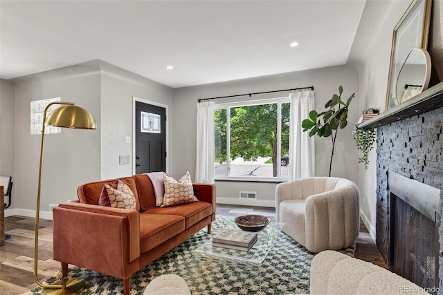 2050 S Wolff St, Denver, CO 80219 - living area with wood finished floors, a stone fireplace, and recessed lighting