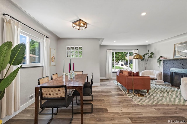2050 S Wolff St, Denver, CO 80219 - dining space featuring recessed lighting, wood finished floors, and a brick fireplace