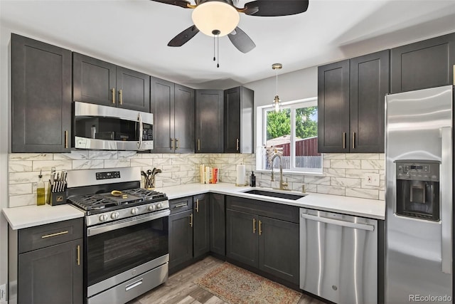 2050 S Wolff St, Denver, CO 80219 - kitchen featuring appliances with stainless steel finishes, backsplash, light countertops, and light wood finished floors