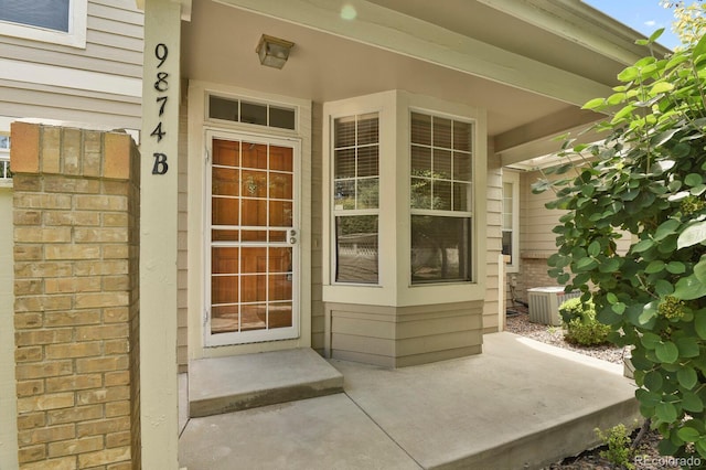 9874 Grove St Unit B, Westminster, CO 80031 - view of exterior entry with a porch and brick siding