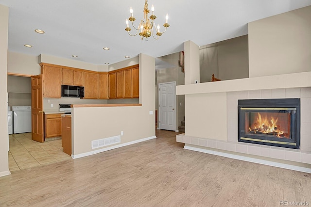 9874 Grove St Unit B, Westminster, CO 80031 - kitchen featuring black microwave, washing machine and dryer, a chandelier, light wood-type flooring, and recessed lighting