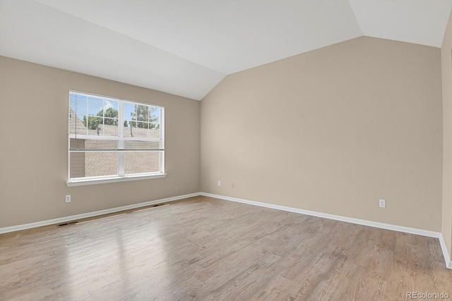 9874 Grove St Unit B, Westminster, CO 80031 - spare room with lofted ceiling and light wood-style floors