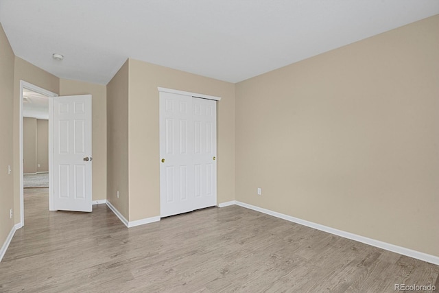 9874 Grove St Unit B, Westminster, CO 80031 - unfurnished bedroom with wood finished floors and a closet