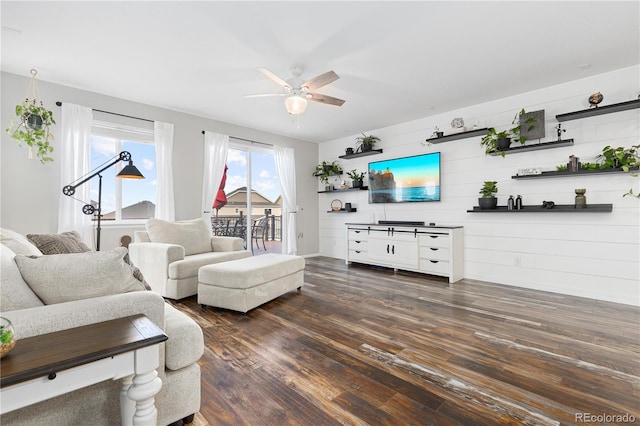 living room featuring dark hardwood / wood-style floors and ceiling fan