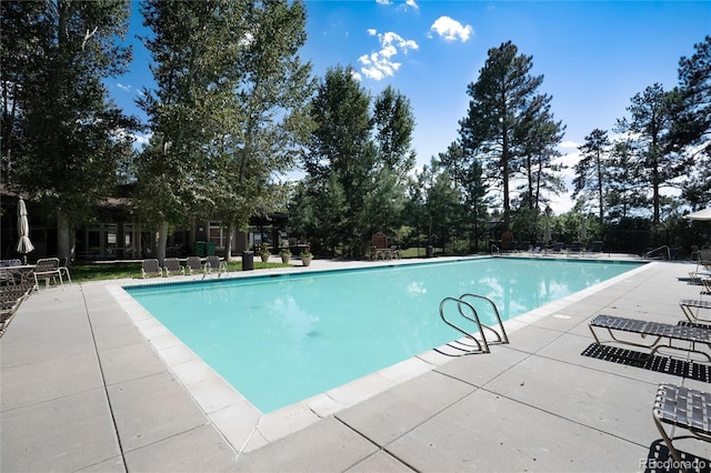 community pool with a patio area