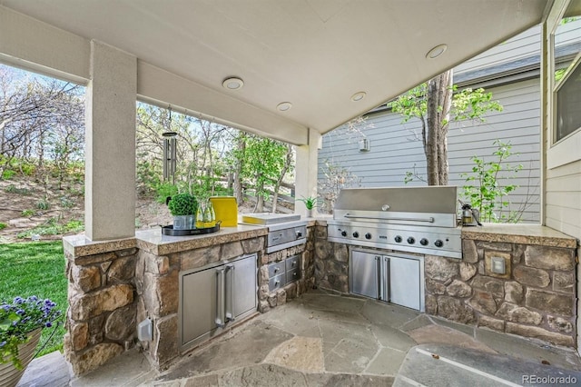 view of patio / terrace featuring a grill and exterior kitchen