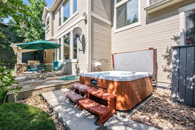 view of patio featuring a hot tub and outdoor dining area