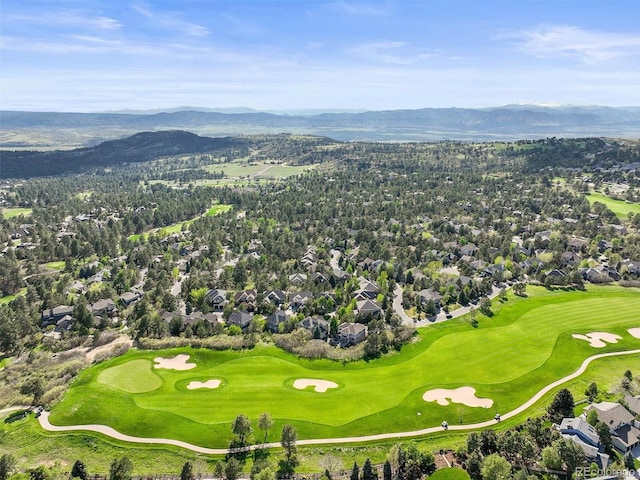 aerial view of residential area with a mountain backdrop and a golf club