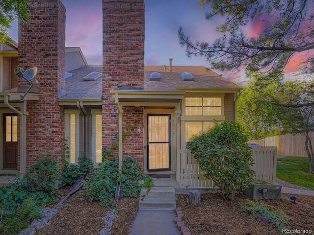 1990 S Helena St Unit H, Aurora, CO 80013 - view of front facade with a shingled roof and a chimney
