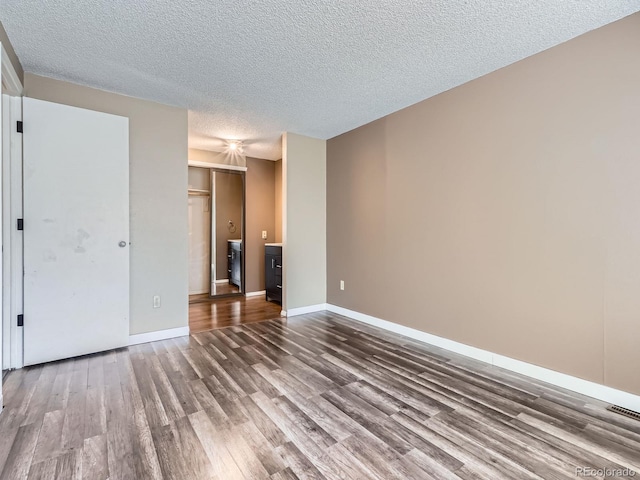 1990 S Helena St Unit H, Aurora, CO 80013 - unfurnished bedroom with wood finished floors and a textured ceiling