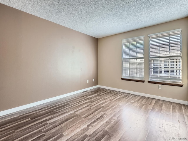 1990 S Helena St Unit H, Aurora, CO 80013 - unfurnished room featuring wood finished floors and a textured ceiling
