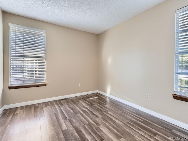 1990 S Helena St Unit H, Aurora, CO 80013 - spare room with wood finished floors and a textured ceiling