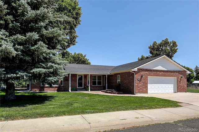 200 E 6th St, Flagler, CO 80815 - single story home with an attached garage, a front yard, driveway, and brick siding