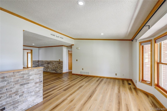 200 E 6th St, Flagler, CO 80815 - unfurnished living room with a textured ceiling, wood finished floors, ornamental molding, and recessed lighting
