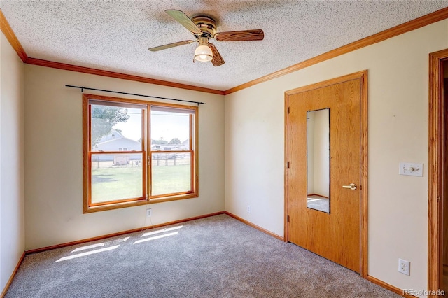 200 E 6th St, Flagler, CO 80815 - spare room featuring ceiling fan, carpet flooring, a textured ceiling, and crown molding