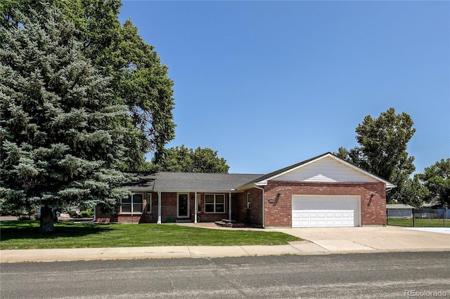 200 E 6th St, Flagler, CO 80815 - single story home featuring an attached garage, brick siding, and driveway