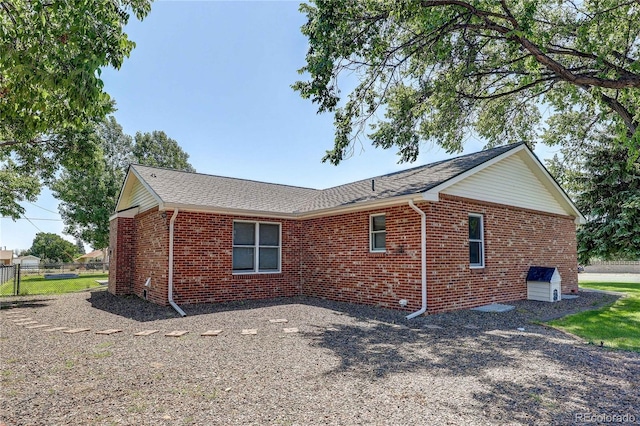 200 E 6th St, Flagler, CO 80815 - view of property exterior with brick siding and roof with shingles