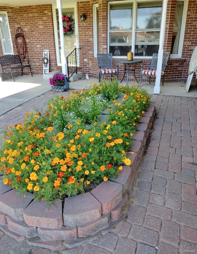 200 E 6th St, Flagler, CO 80815 - view of exterior entry with a porch and brick siding
