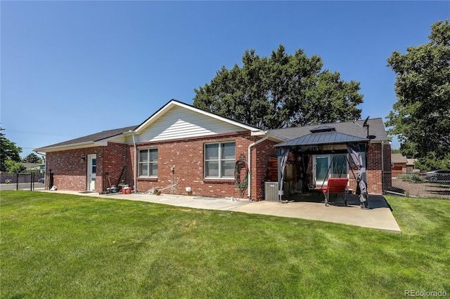 200 E 6th St, Flagler, CO 80815 - back of house featuring a gazebo, brick siding, and a patio