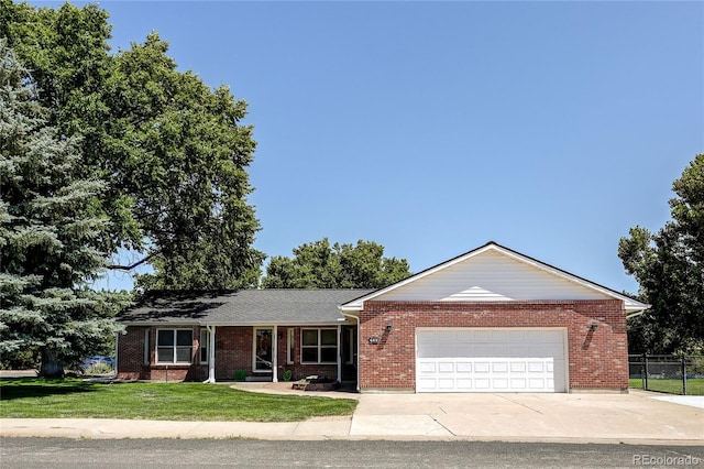 200 E 6th St, Flagler, CO 80815 - ranch-style home with a garage, driveway, and brick siding