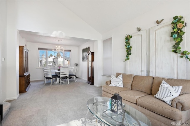 carpeted living room featuring an inviting chandelier and vaulted ceiling