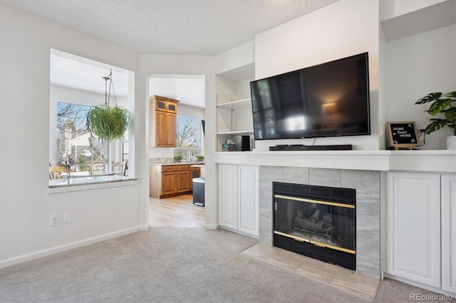 carpeted living room with a fireplace and a textured ceiling