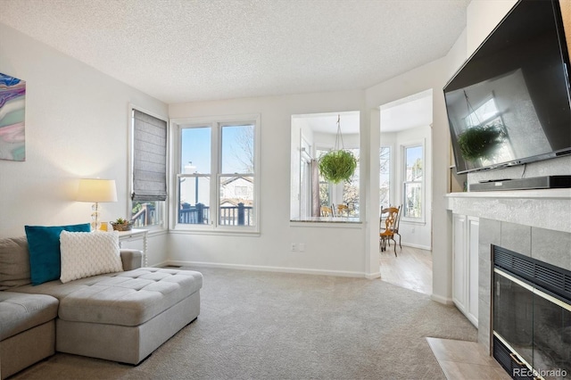 living room with a textured ceiling, light colored carpet, and a fireplace