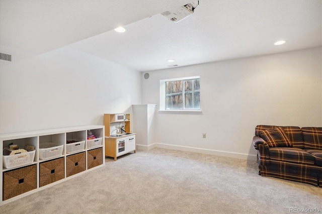 living area featuring light colored carpet