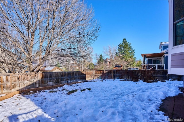 view of yard layered in snow