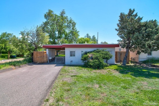 1560 Simms St, Lakewood, CO 80215 - ranch-style house featuring driveway, stucco siding, and an attached carport