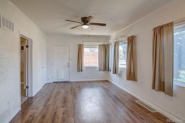 1560 Simms St, Lakewood, CO 80215 - empty room featuring ornamental molding, plenty of natural light, wood finished floors, and a ceiling fan