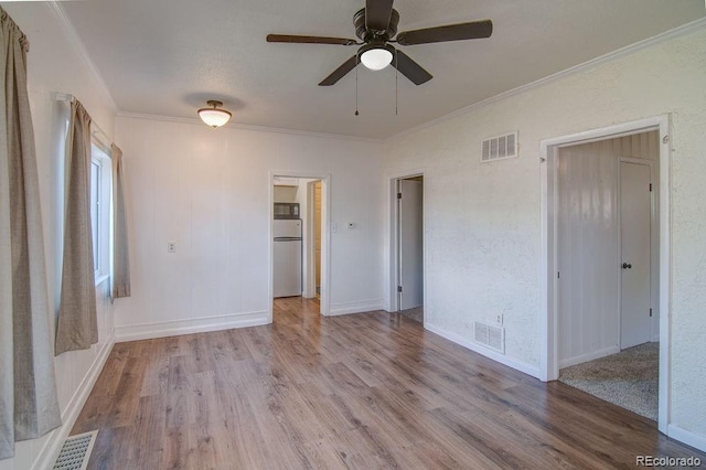 1560 Simms St, Lakewood, CO 80215 - unfurnished bedroom featuring refrigerator, crown molding, wood finished floors, and baseboards