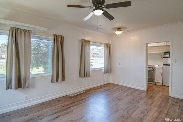 1560 Simms St, Lakewood, CO 80215 - spare room featuring wood finished floors, ornamental molding, ceiling fan, and baseboards
