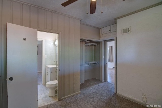 1560 Simms St, Lakewood, CO 80215 - unfurnished bedroom featuring a closet, connected bathroom, a sink, a textured ceiling, and crown molding