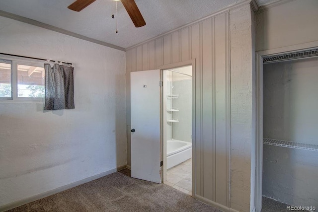 1560 Simms St, Lakewood, CO 80215 - unfurnished bedroom featuring crown molding, ensuite bathroom, carpet floors, a ceiling fan, and a closet