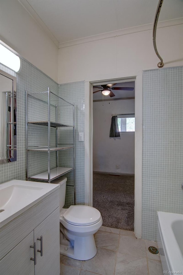 1560 Simms St, Lakewood, CO 80215 - bathroom with tile patterned flooring, vanity, toilet, ceiling fan, and crown molding