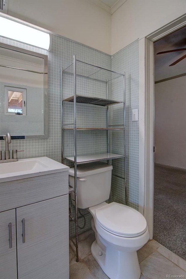 1560 Simms St, Lakewood, CO 80215 - bathroom with toilet, vanity, and a ceiling fan