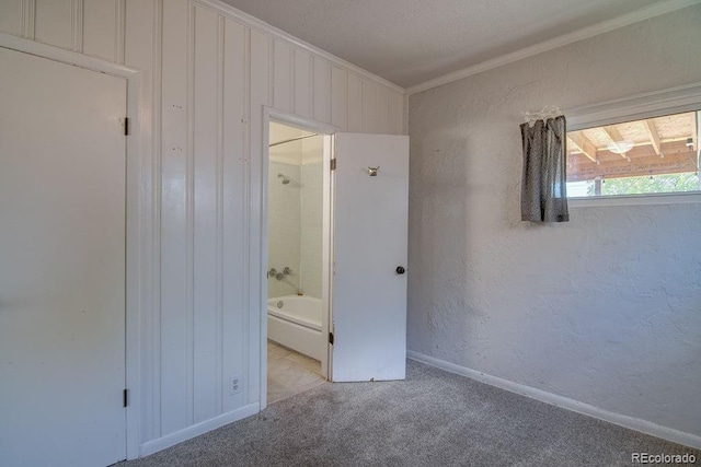 1560 Simms St, Lakewood, CO 80215 - unfurnished bedroom featuring crown molding, carpet floors, baseboards, a textured wall, and ensuite bath