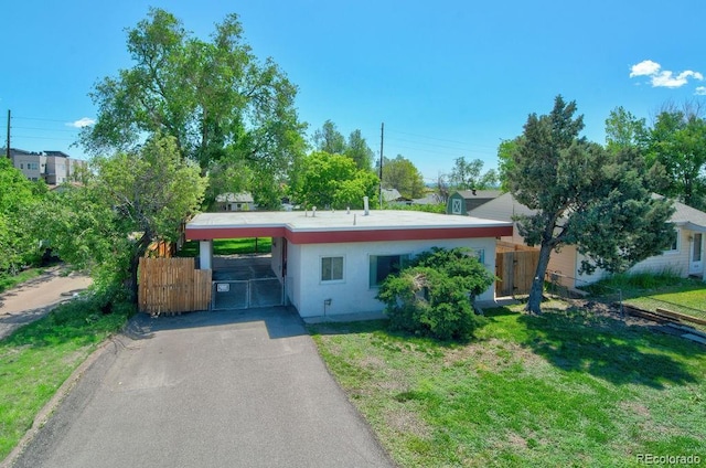 1560 Simms St, Lakewood, CO 80215 - view of front of property with asphalt driveway, an attached carport, and stucco siding