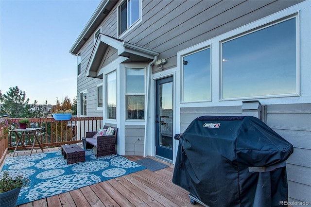 wooden deck with a grill and an outdoor living space