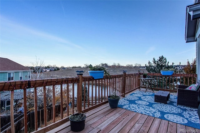 deck featuring outdoor lounge area and a water view