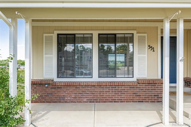 551 Snowy Owl Pl, Highlands Ranch, CO 80126 - view of exterior entry featuring covered porch and brick siding
