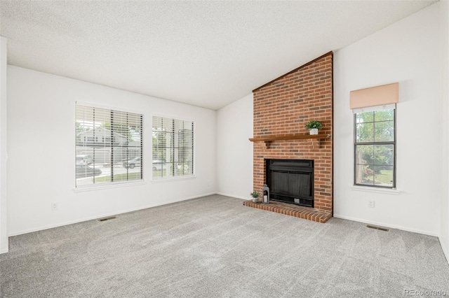 551 Snowy Owl Pl, Highlands Ranch, CO 80126 - unfurnished living room with carpet, a brick fireplace, lofted ceiling, and a textured ceiling